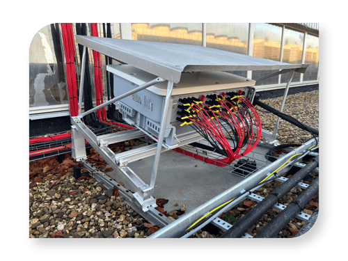 compact pv shelter with DC cables in cable baskets on a gravel roof compact pv shelter with DC cables in cable baskets on a gravel roof